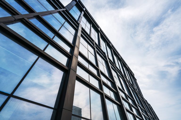 Clouds reflected in windows of modern office building